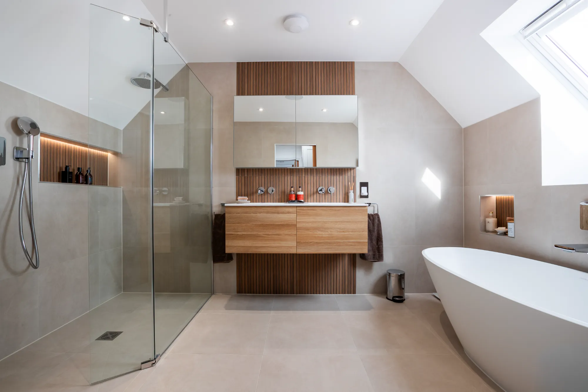 A bathroom with a tub, sink, and shower.